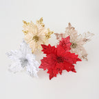 Golden glitter Christmas flower arrangement displayed on rustic Christmas decor with warm tones