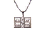 Close-up of turnable book pendant design featuring Jesus Christ motif