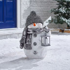 Festive snowman ornament with red winter clothing displayed on Christmas tree