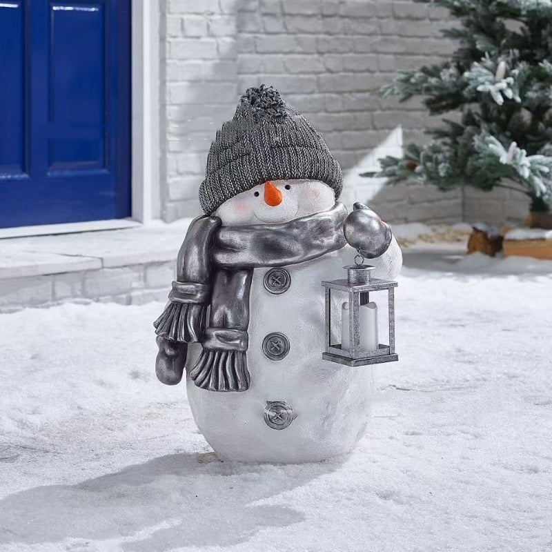 Festive snowman ornament with red winter clothing displayed on Christmas tree