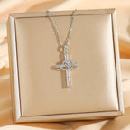 Close-up of cross and heart pendant with zircon accents in gold