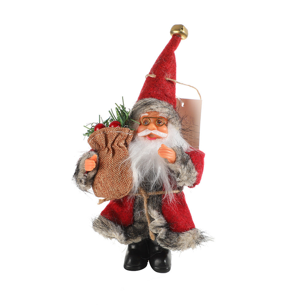 Pink faceless Santa Claus standing doll near Christmas tree