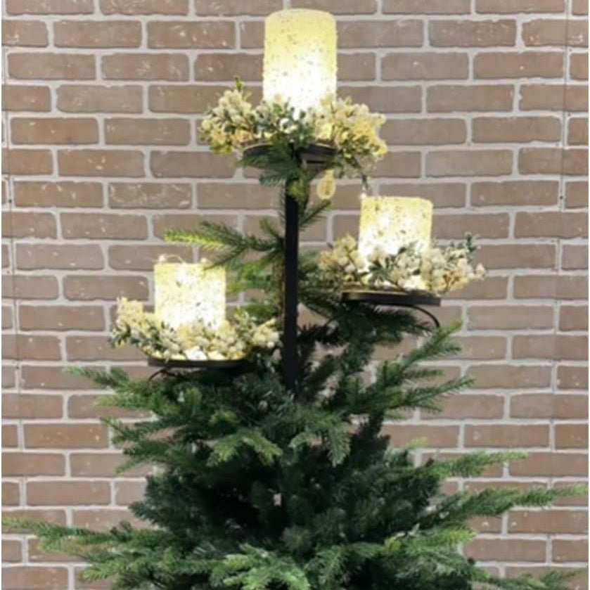 Cozy living room with decorated Christmas tree featuring iron candlestick topper