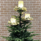 Cozy living room with decorated Christmas tree featuring iron candlestick topper