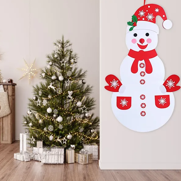 Child hands placing felt decorations on snowman body