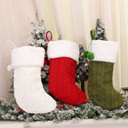Close-up of white knitted Christmas sock ornament with festive stripes