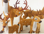 Miniature flocked deer ornaments showcasing woodland Christmas style