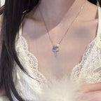Delicate cross necklace with pearl and zircon pendant on elegant chain