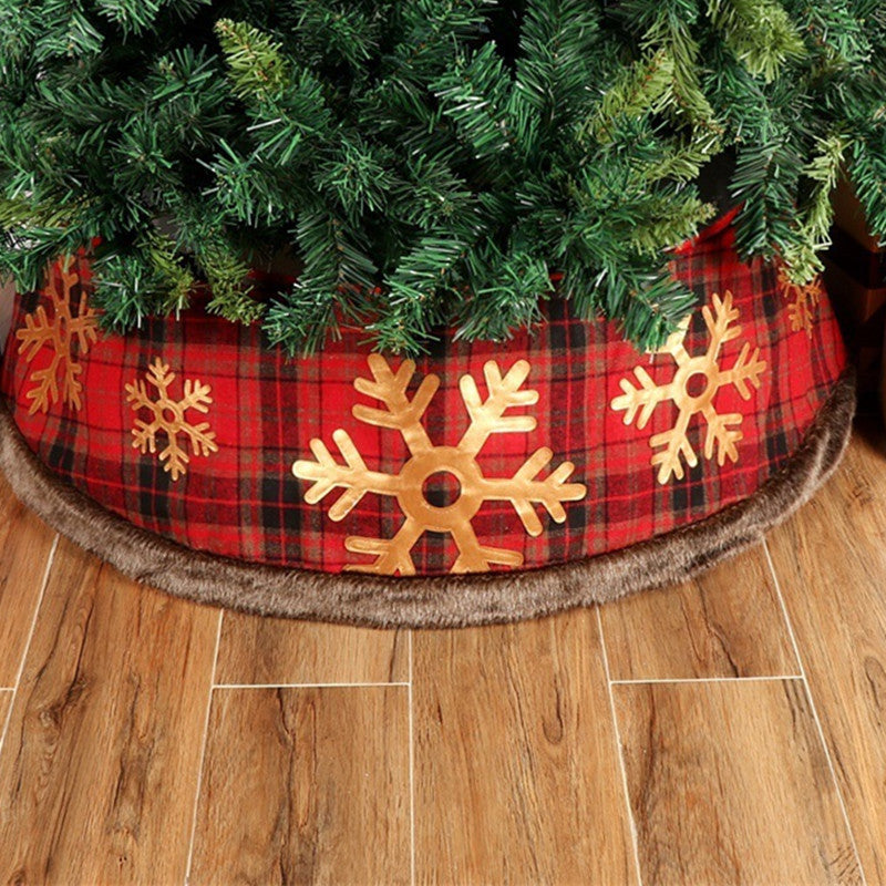 Plaid snowflake Christmas tree skirt displayed flat with festive winter ambiance