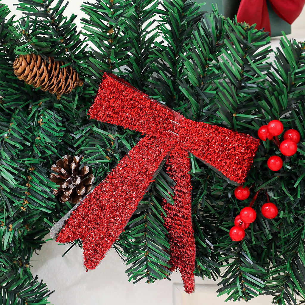 Rattan pine cone bow Christmas decoration arranged on white surface with warm holiday ambiance