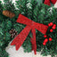 Rattan pine cone bow Christmas decoration arranged on white surface with warm holiday ambiance