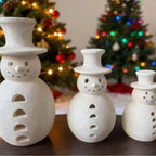 Large retro snowman resin ornament as festive mantle decoration during Christmas season