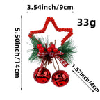 Five-pointed star bell ornament in gold hanging on a Christmas tree with warm lights