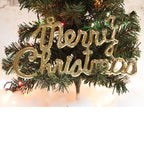 Group of white pine cone pendant ornaments arranged on festive wrapping paper