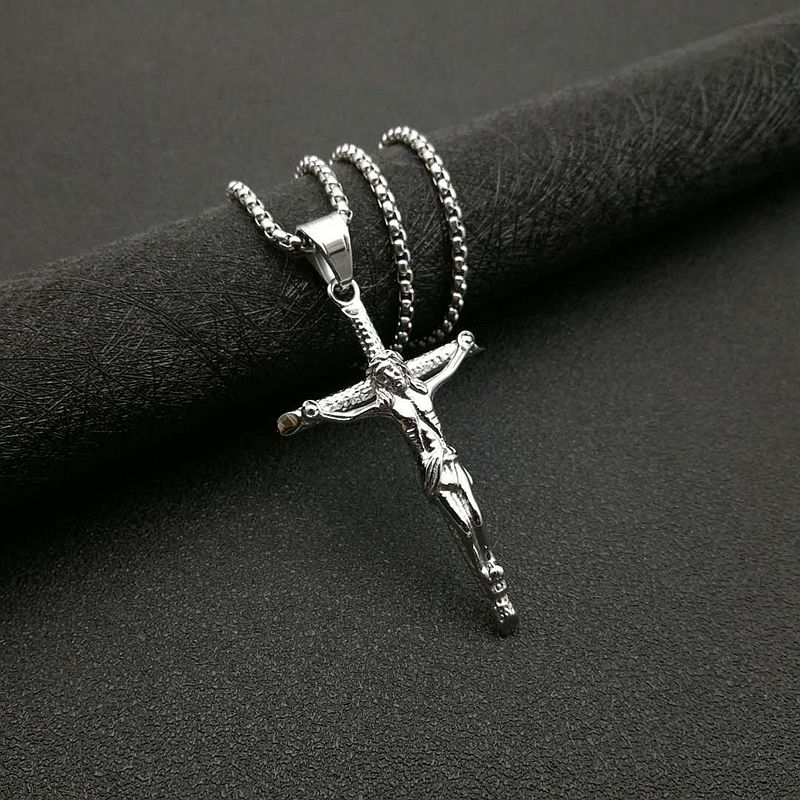 Person wearing gilded cross necklace as daily faith accessory