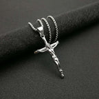 Person wearing gilded cross necklace as daily faith accessory