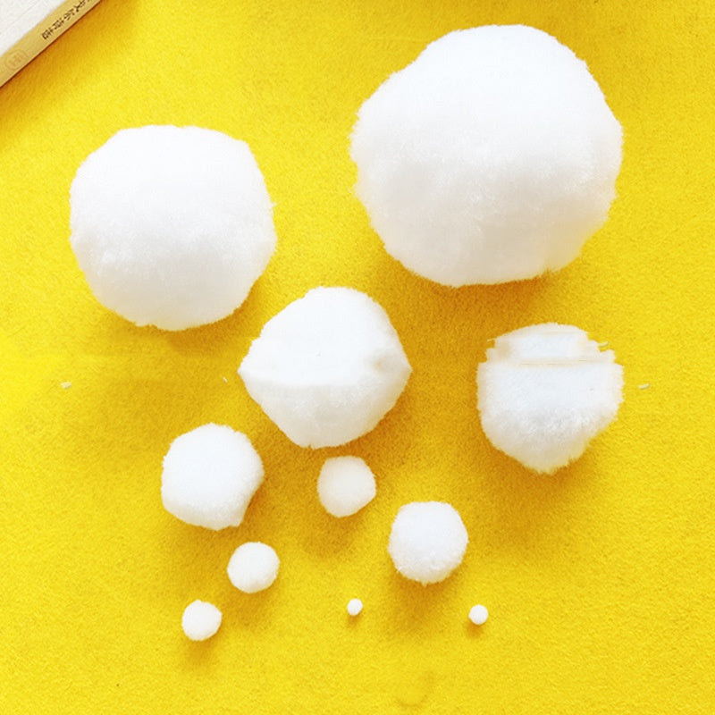 White ornament balls arranged with festive greenery and decorations