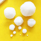 White ornament balls arranged with festive greenery and decorations