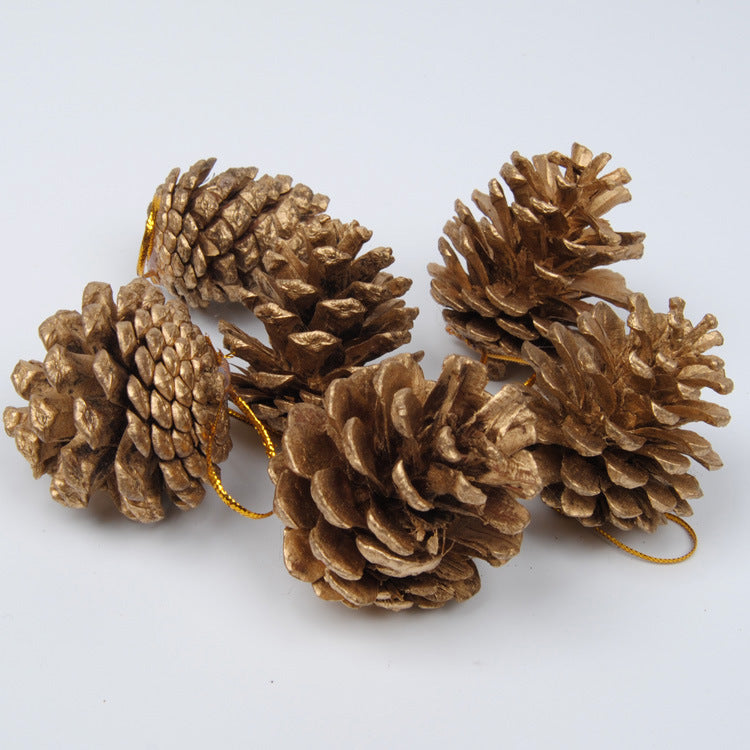 Gold and silver pine cone pendant set displayed together on rustic surface with pine branches for Christmas decor Main image