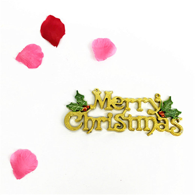 Gold Christmas nameplate pendant hanging among holiday decorations
