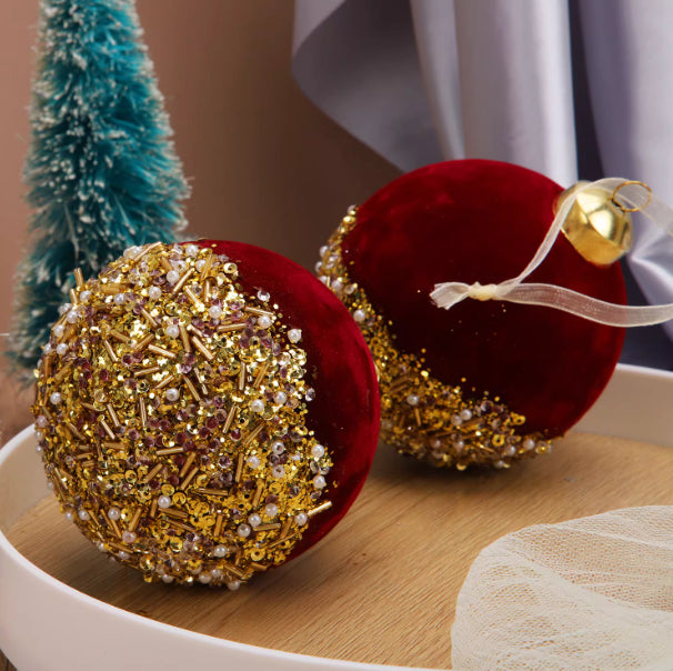 Elegant burgundy flocked glass ornament reflecting light in festive setting
