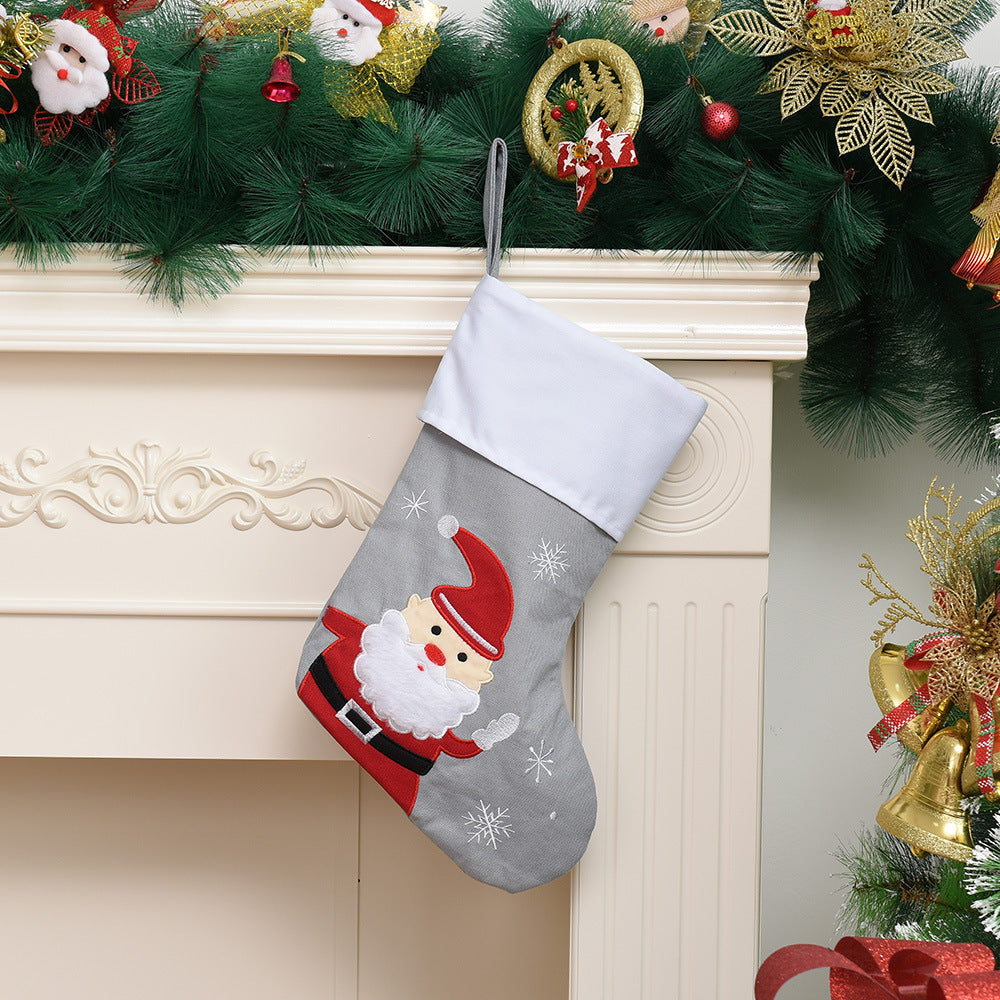 Festive Christmas stocking featuring Santa Claus in gray fabric