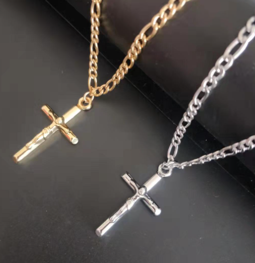 Close-up of 4mm Figaro chain and cross pendant showing titanium steel details