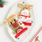 Red Christmas gift bags laid out flat, ready for filling with cookies and baked goods