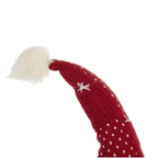 Festive gnome decorations displayed on a holiday dining table with evergreen branches