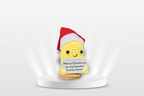 Yellow and green plush Christmas decoration displayed on a festive surface with warm holiday ambiance