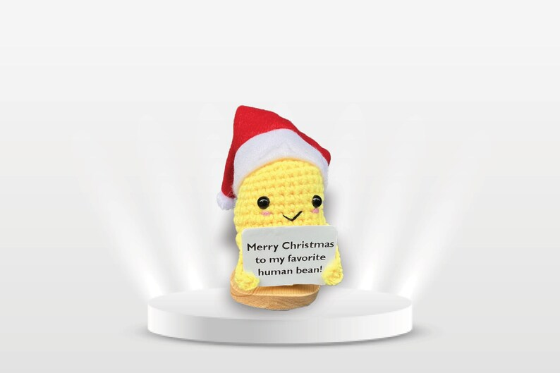 Yellow and green plush Christmas decoration displayed on a festive surface with warm holiday ambiance