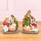 Resin nativity ornament hanging on decorated Christmas tree branch