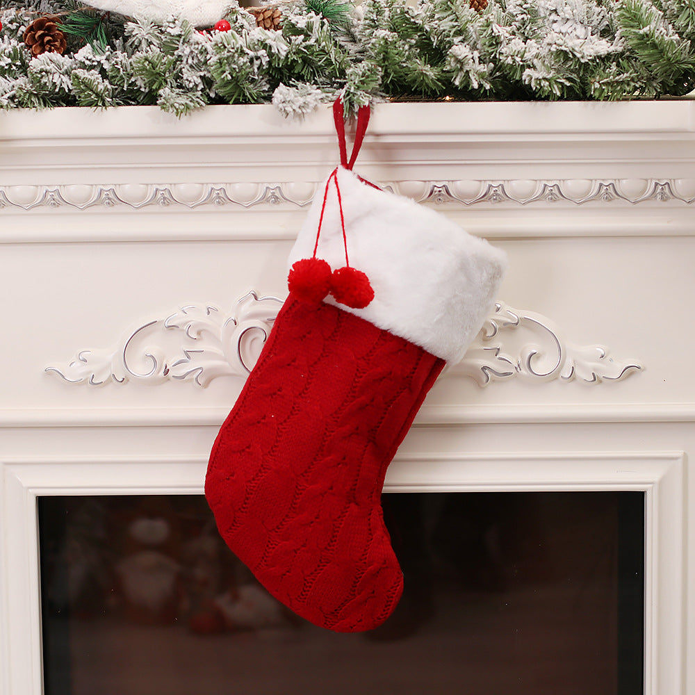 Green knitted Christmas sock ornament displaying traditional holiday colors