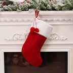 Green knitted Christmas sock ornament displaying traditional holiday colors