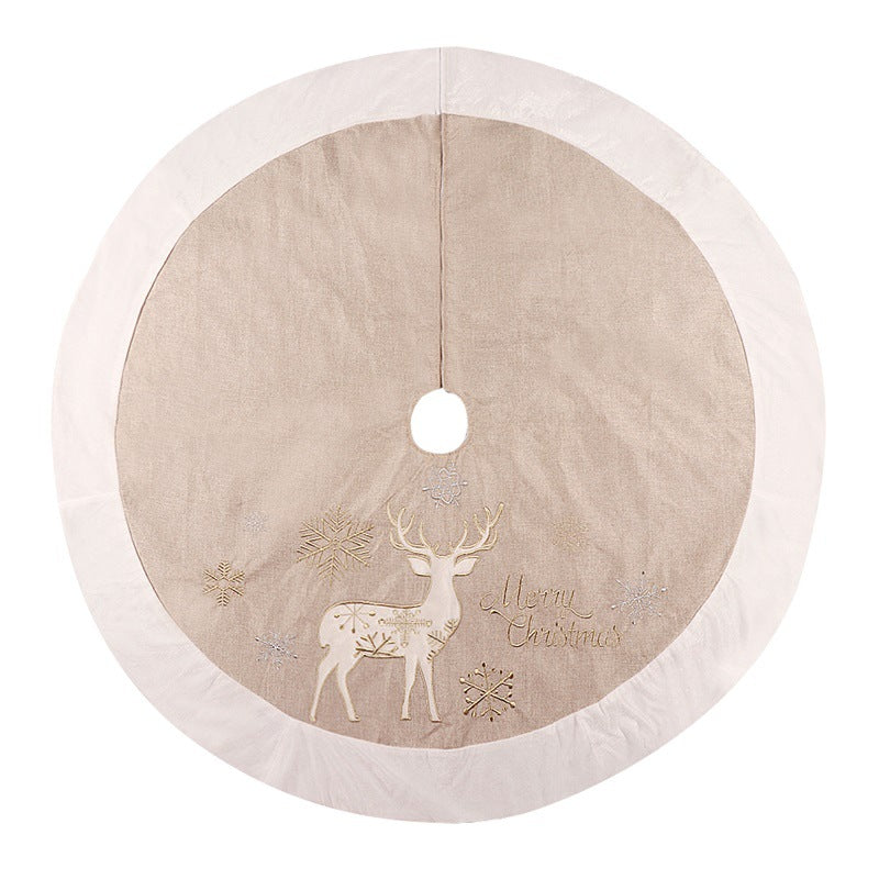 Gold and white linen Christmas tree skirt draped around a decorated holiday tree Main image