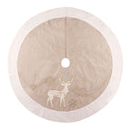 Gold and white linen Christmas tree skirt draped around a decorated holiday tree