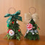 Red and green mini Christmas tree ornament on white background
