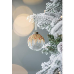 Close-up of glass ornament showing painted details and glitter accents
