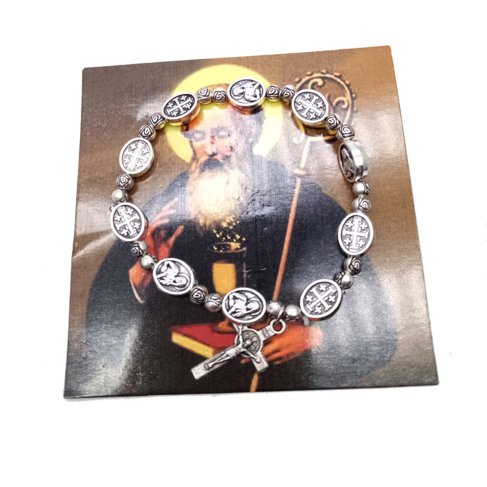 Madonna figure and cross pendants hanging from rose bead rosary strand