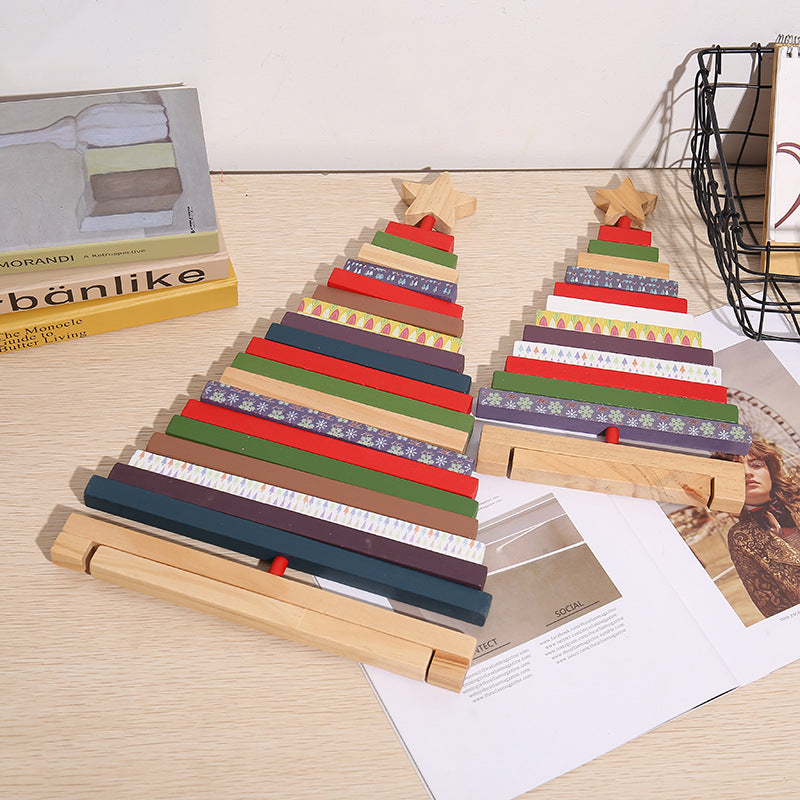 Festive desktop arrangement featuring rotating Christmas tree building block decor