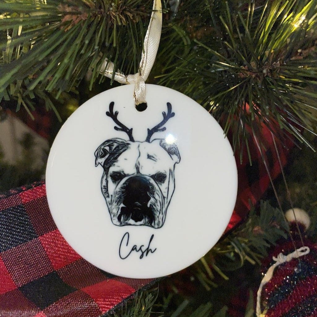 White porcelain pet portrait ornament hanging on Christmas tree branch
