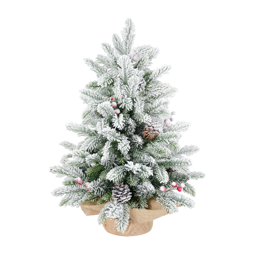 Decorated tabletop Christmas tree with natural-looking pine cones and berries
