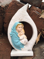 Close-up detail of hand painted Virgin Mary holding baby Jesus figurine