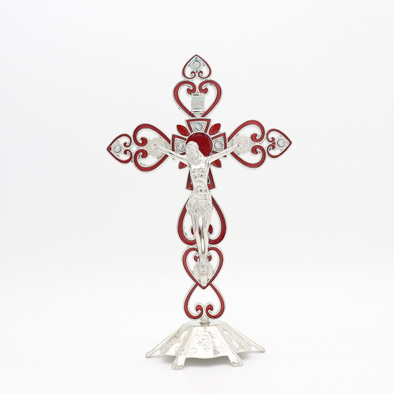 Golden red cross ornament displayed on white surface with reverent lighting Main image