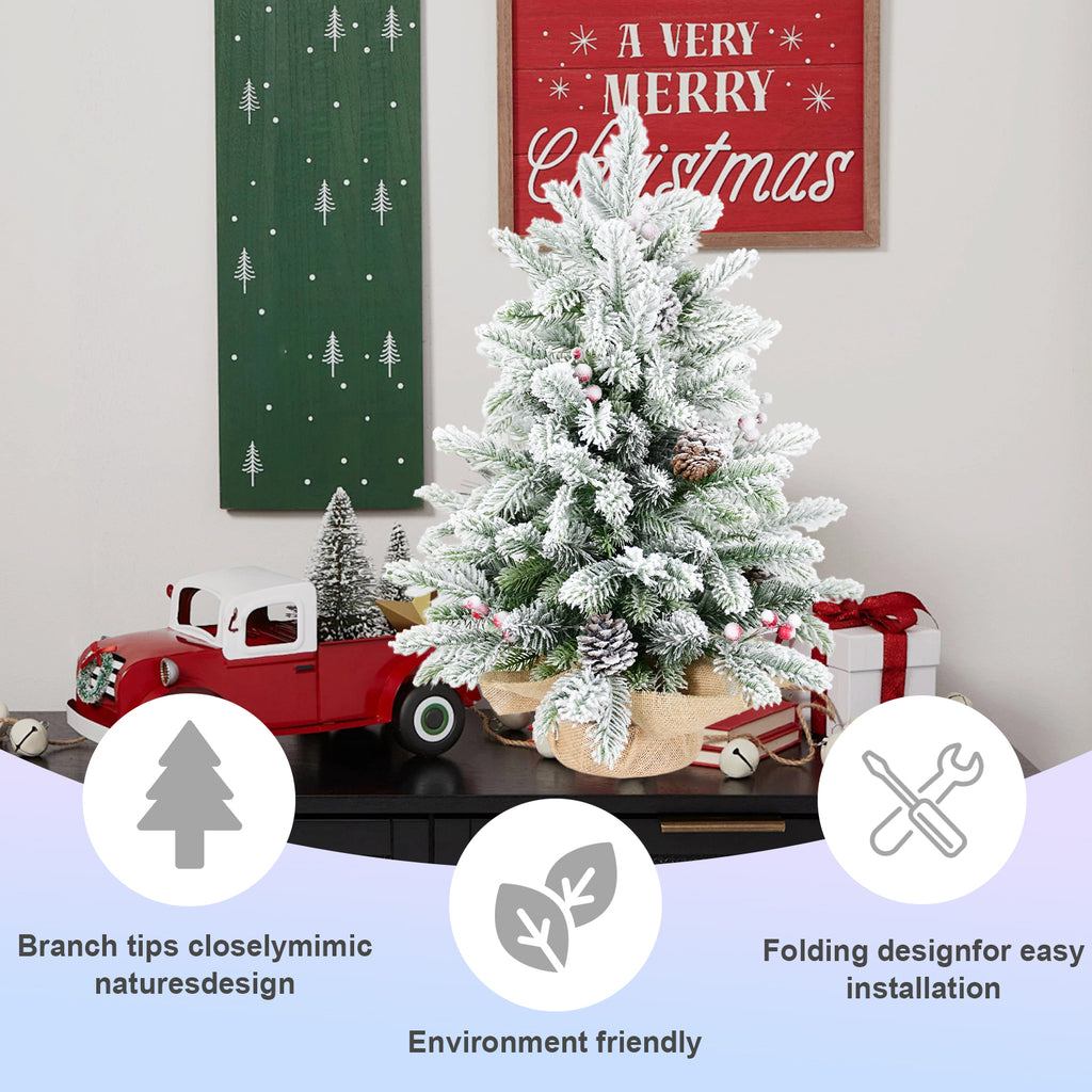 Snow flocking detail on green artificial Christmas tree branches