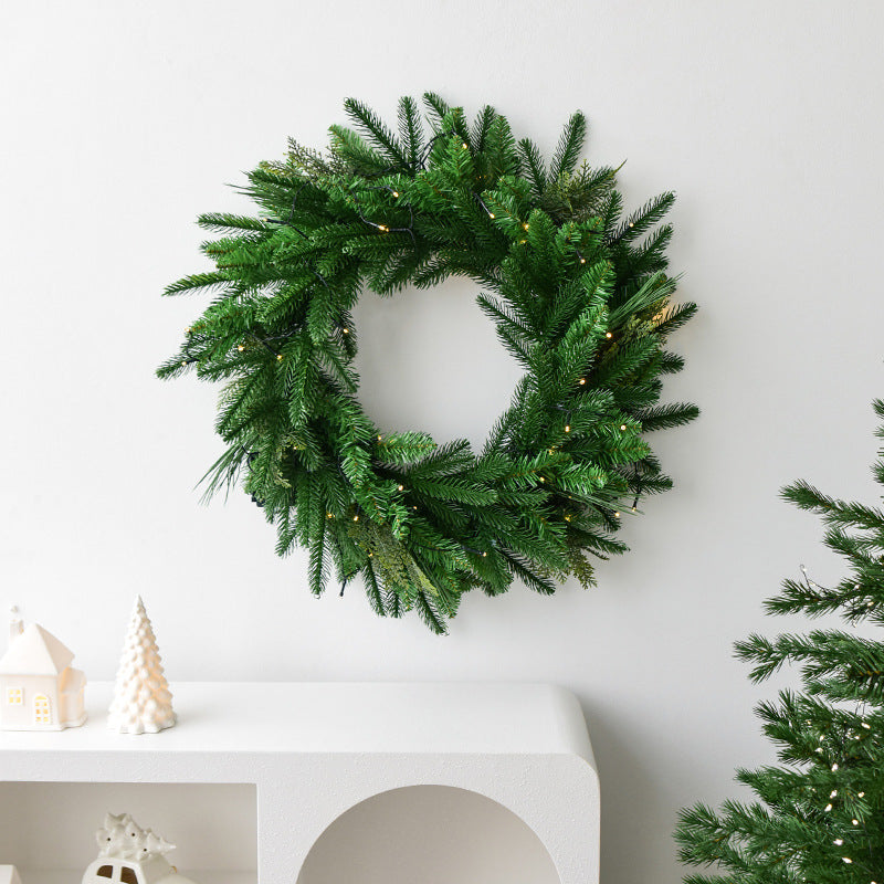 Close-up of pine leaf garland craftmanship with glowing lamp lights