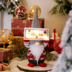 Holiday ornament displaying Santa with light sign