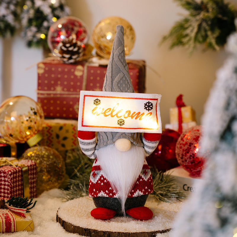 Holiday ornament displaying Santa with light sign