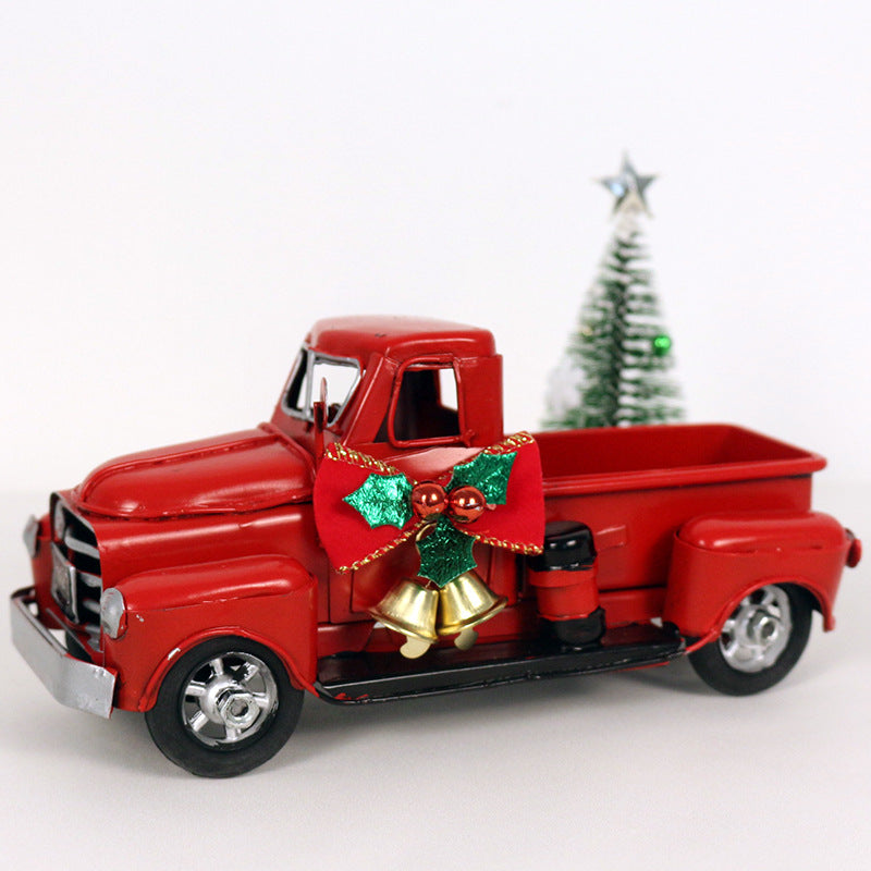 Wrought iron Christmas ornament featuring classic red truck design