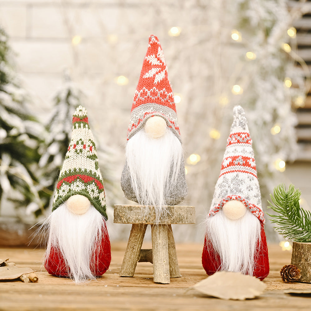 Snowflake knitted hat forest doll ornament displayed on Christmas tree branch with red berries